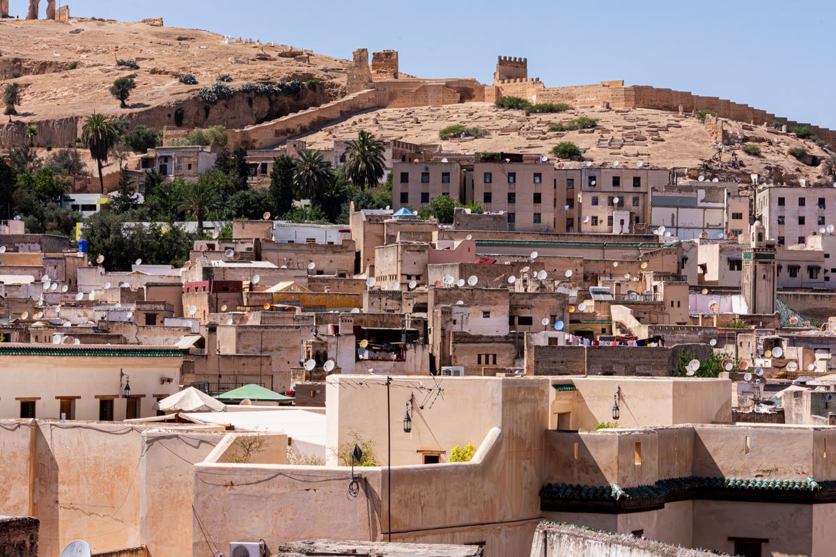 Cityscape of the Fes medina with old walls on the hill, Morocco