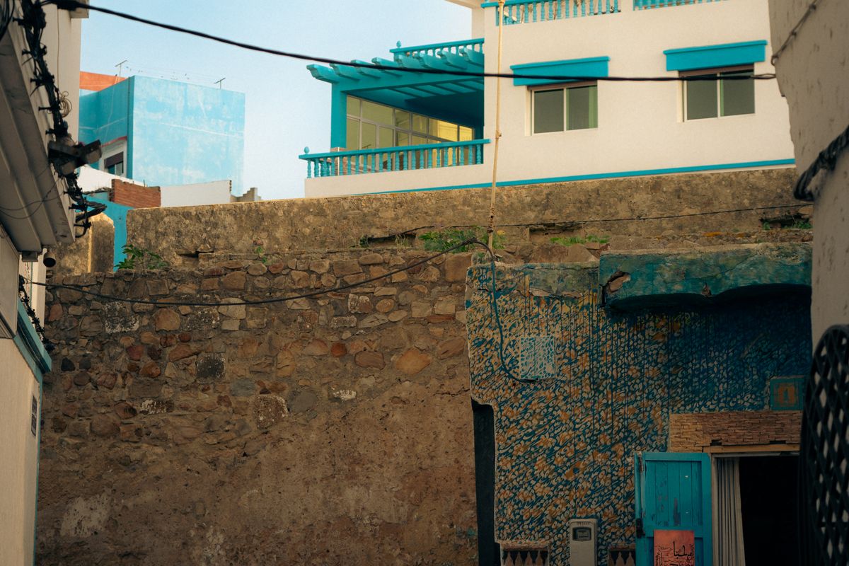 A street in the Asilah medina with colourful wall murals, Morocco