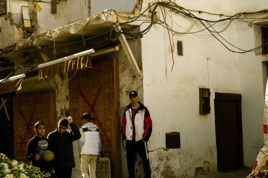 A busy street scene in a traditional market in Morocco with shoppers and stalls