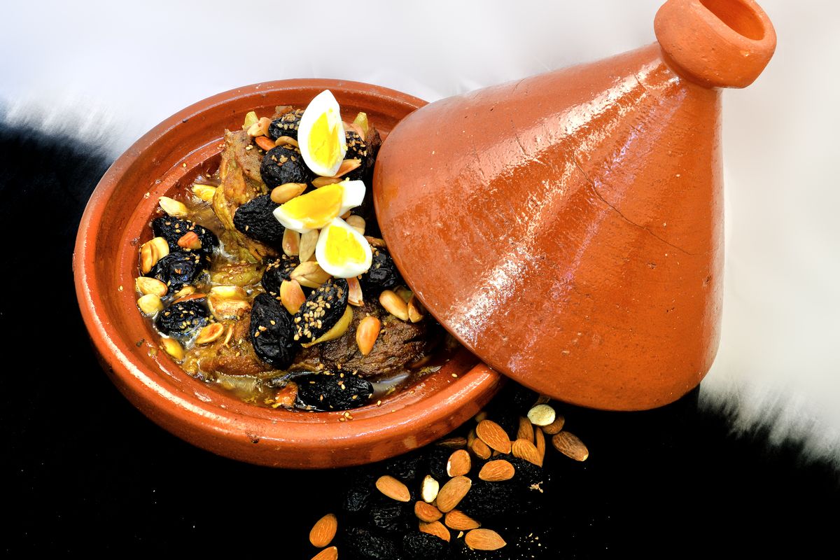 Lamb tagine with almonds, prunes and eggs in a clay pot in Fes, Morocco