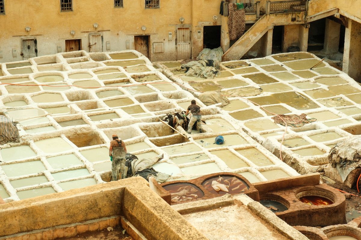 Workers in the dye vats of a traditional leather tannery in Fes, Morocco