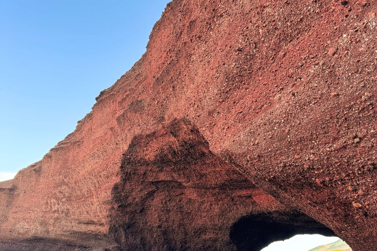 Natural red stone arch on the sand at Legzira Beach, Sidi Ifni coast, Morocco