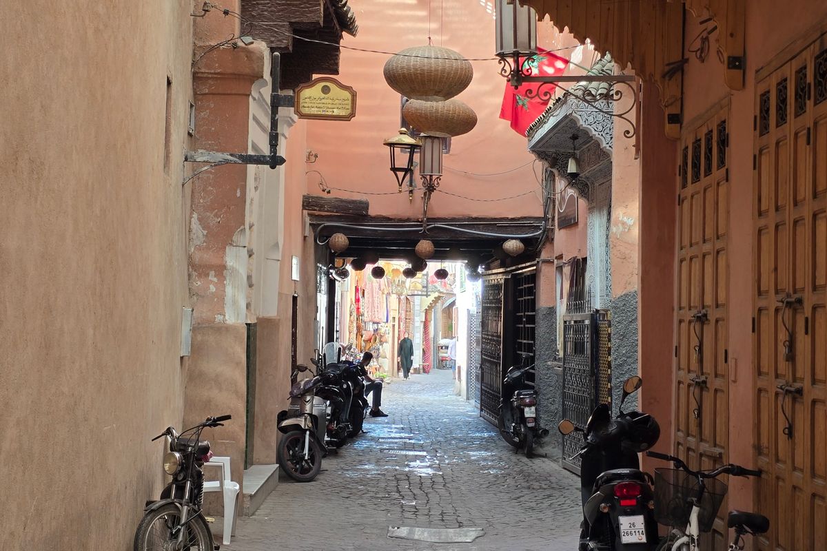 A narrow alleyway with traditional buildings in the medina of Marrakech, Morocco
