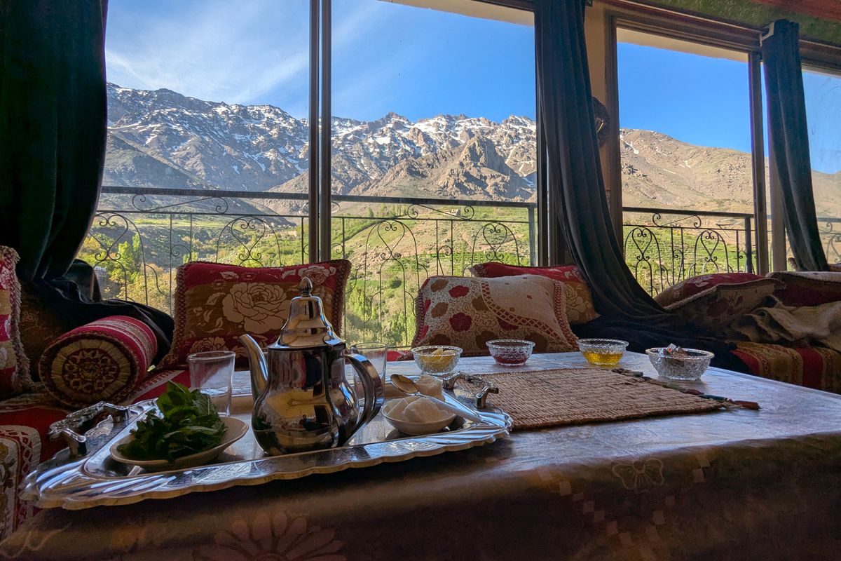 A Moroccan tea set in front of the High Atlas mountains at Tachdirt, Morocco