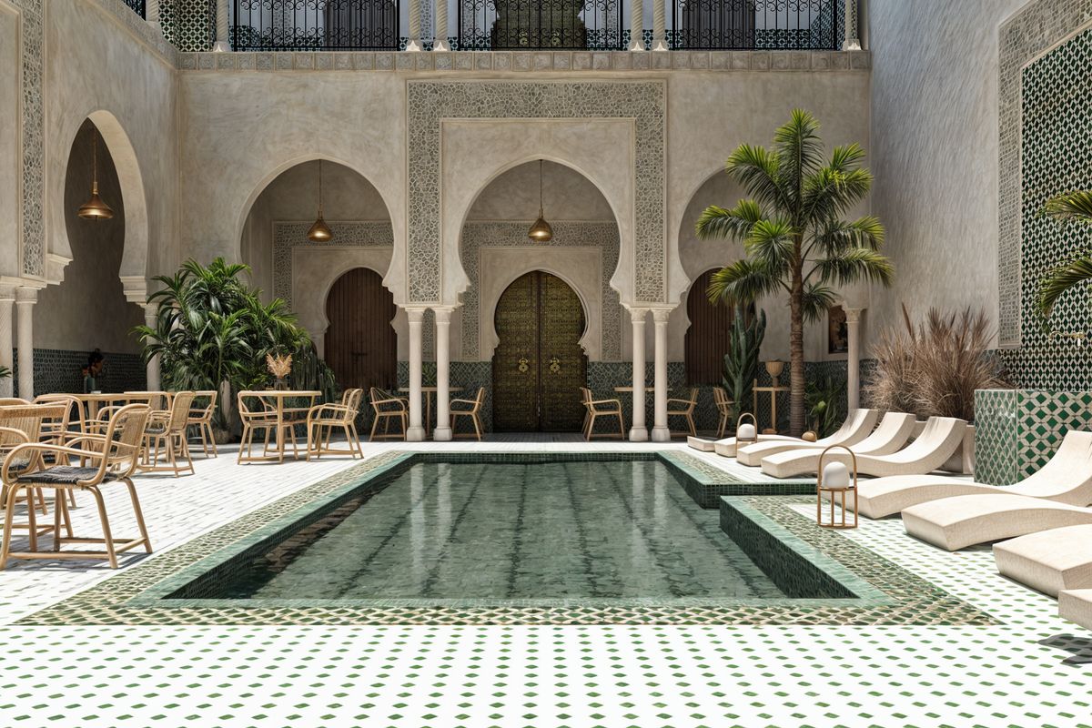 Moroccan riad courtyard with carved arches, green zellige tiles and a central pool