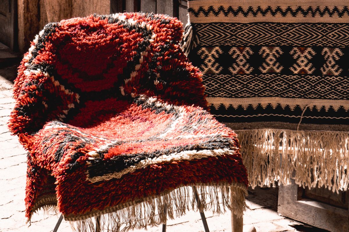 Handcrafted Moroccan rugs displayed in a market in Marrakech, Morocco