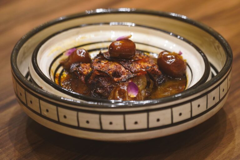 Traditional Moroccan tagine with dates served in a decorative bowl in Essaouira, Morocco
