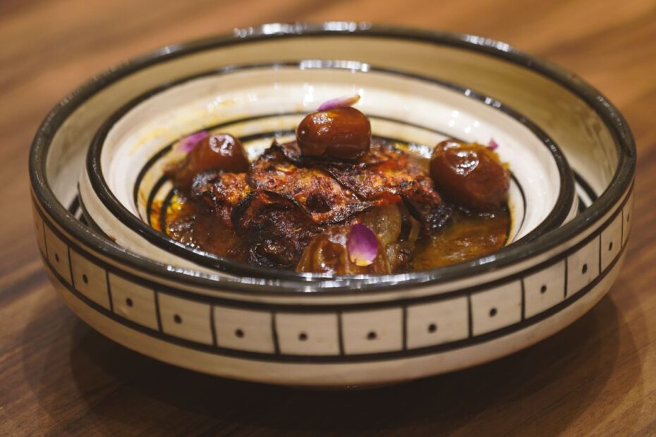 Traditional Moroccan tagine with dates served in a decorative bowl in Essaouira, Morocco