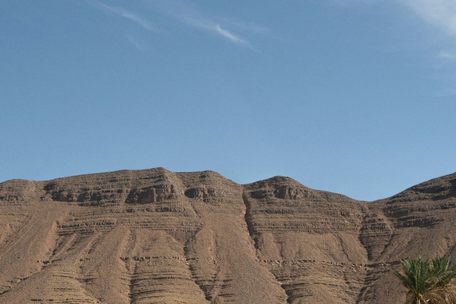 How to get around Morocco: road crossing a desert landscape with mountains