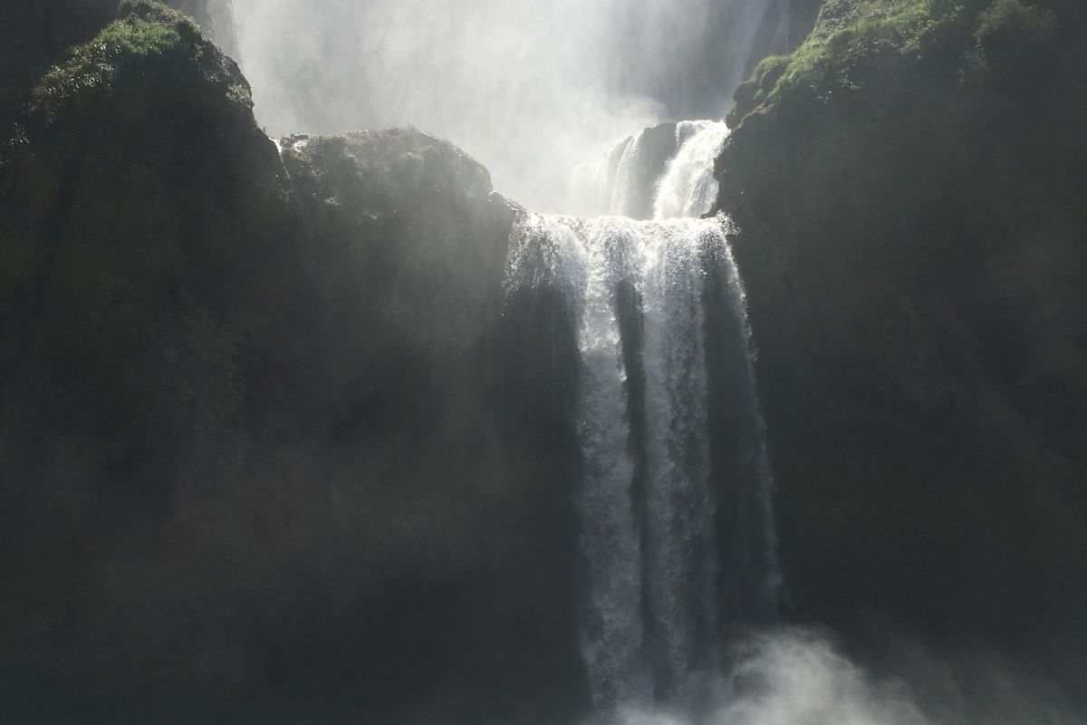 Visitors on a raft in the pool below Ouzoud Falls, Morocco