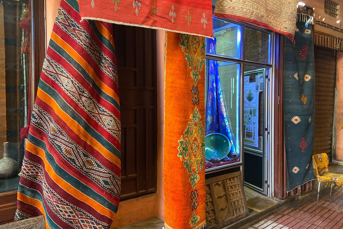 Colourful handmade rugs hanging in a market in Taroudant, Morocco