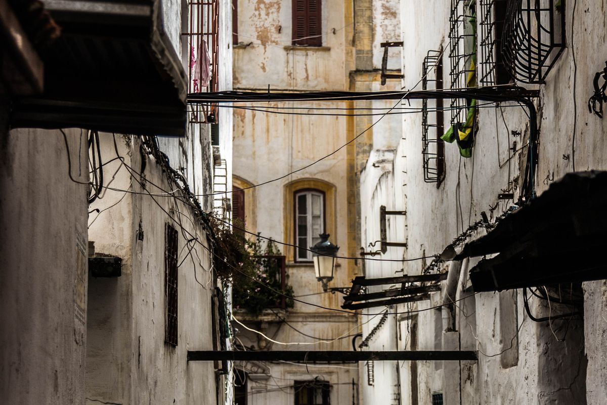 Shoppers walking along a crowded narrow street in the old medina of Tetouan, Morocco